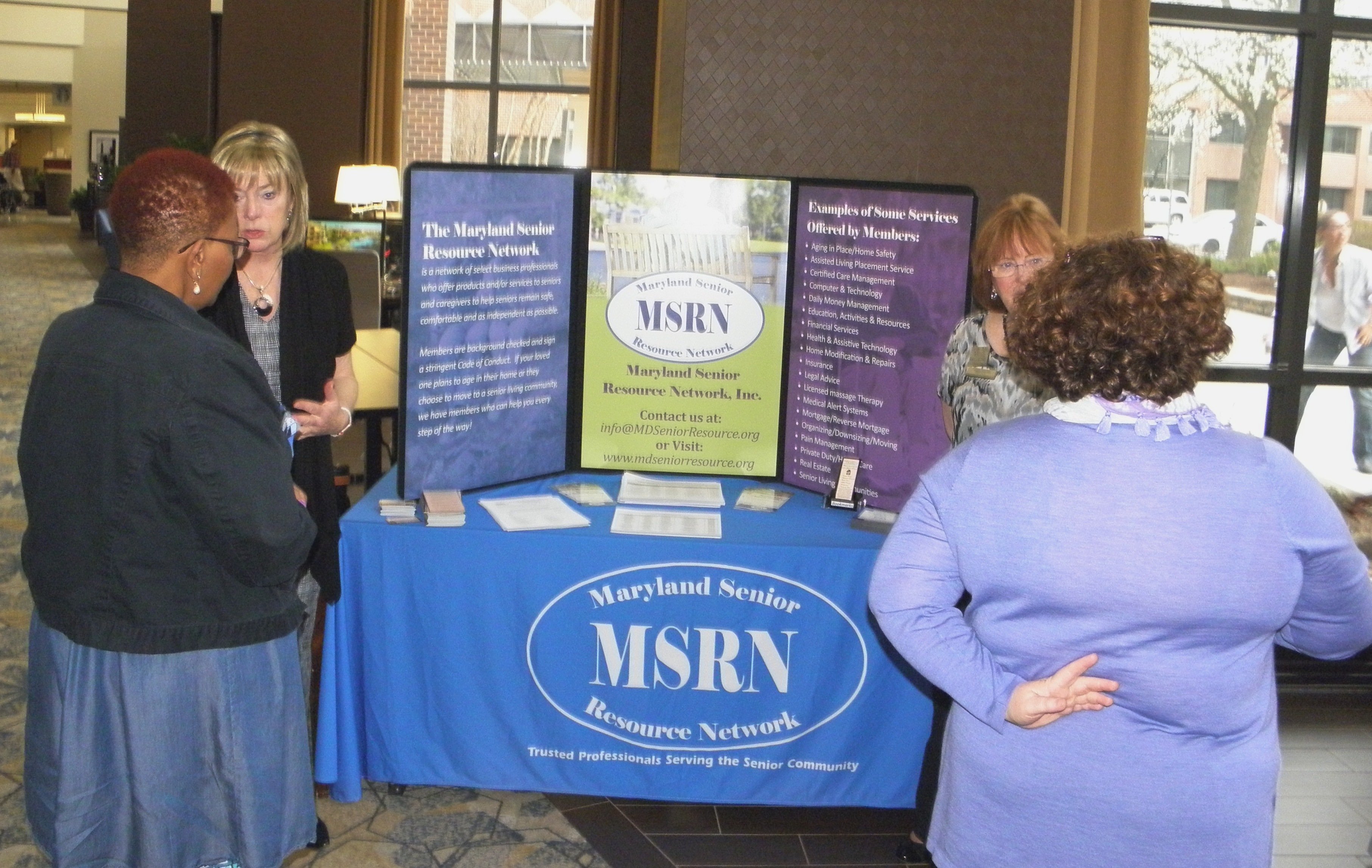 Deb Bakalich, left and Patti Farrell, right, talking with people at the MSRN table